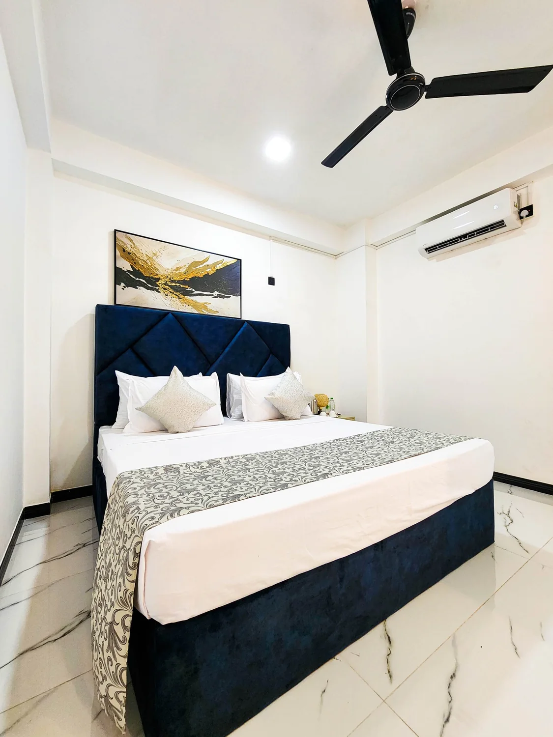 Villa 777 bedroom with blue bedding and warm wooden furniture
